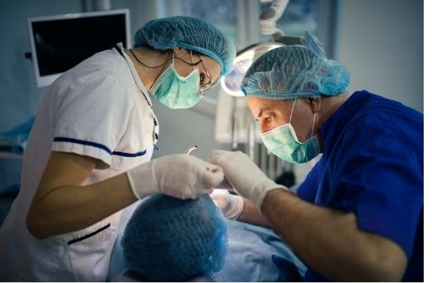 Dentist performing crown lengthening surgery