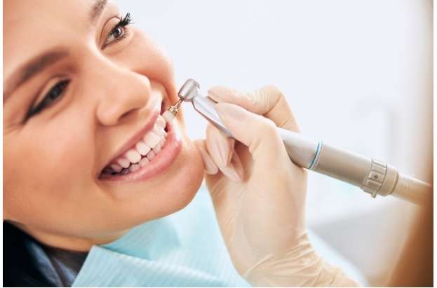 Dentist performing deep cleaning on a patient
