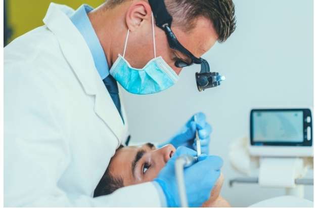 Dentist performing root canal procedure