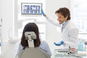 dentist reviewing digital xrays with patient